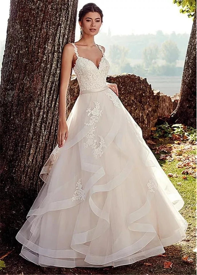 Vestido de novia de tirantes con olanes